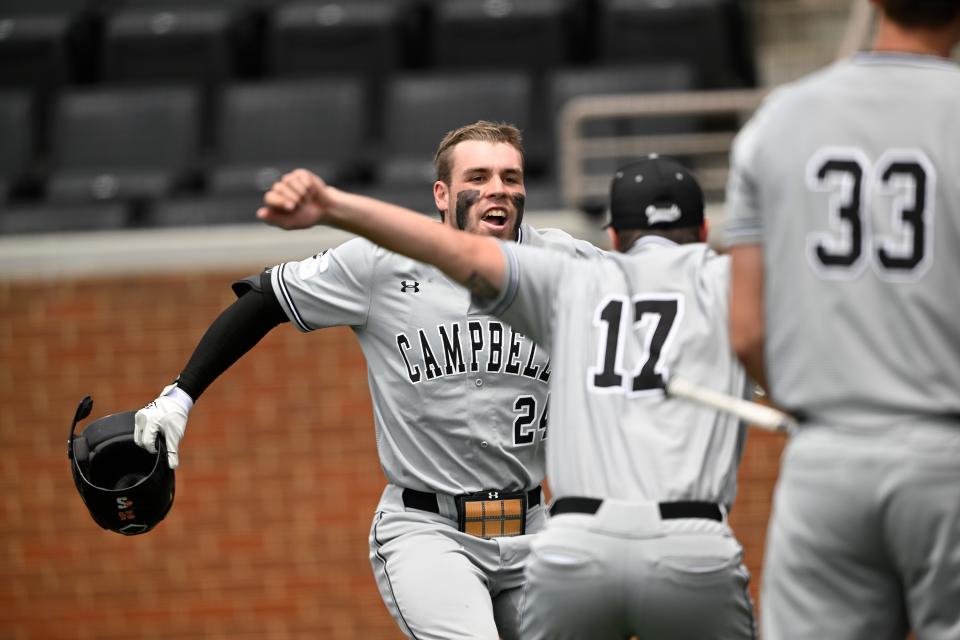 Campbell's Jarrod Belbin celebrates at home plate with Cade Kuehler (17) after hitting a home run against Georgia Tech in an NCAA baseball game on Friday, June 3, 2022, in Knoxville, Tenn. (AP Photo/John Amis)