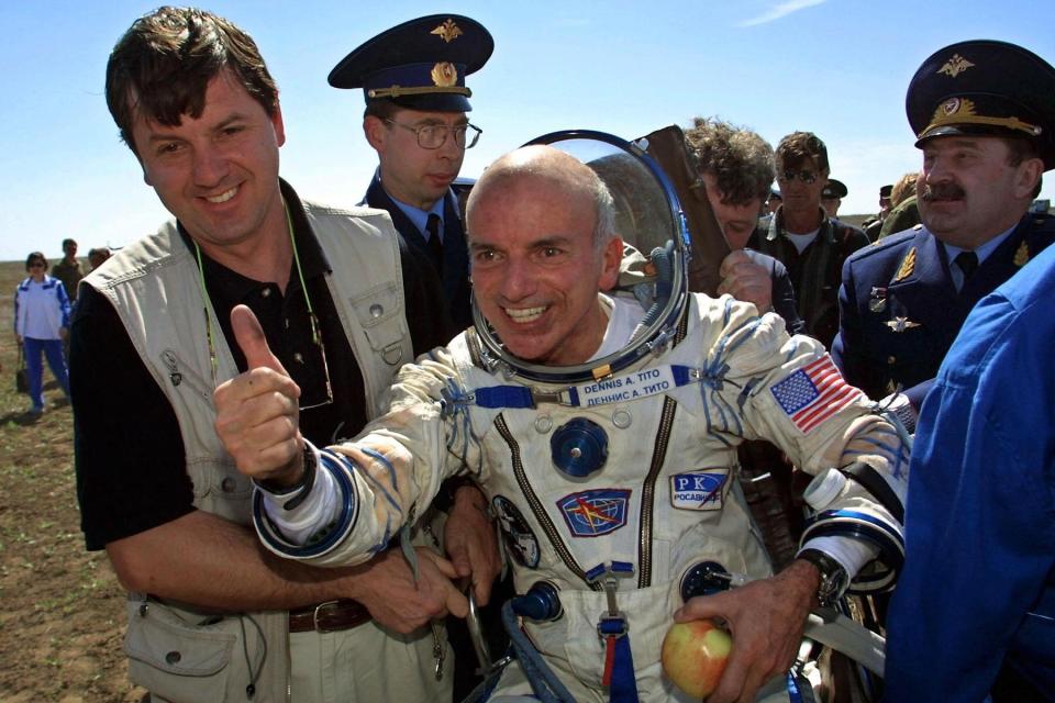 Dennis Tito celebrates after his landing