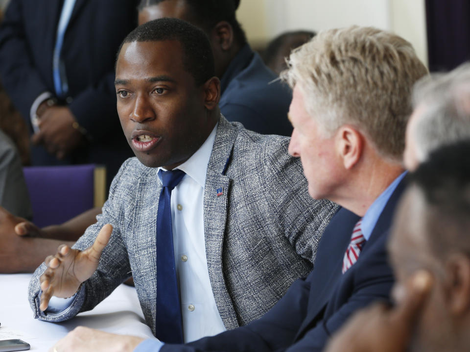 Richmond Mayor Levar Stoney, left, gestures during a gun violence prevention roundtable discussion in Richmond, Va., Monday, June 17, 2019. (AP Photo/Steve Helber)