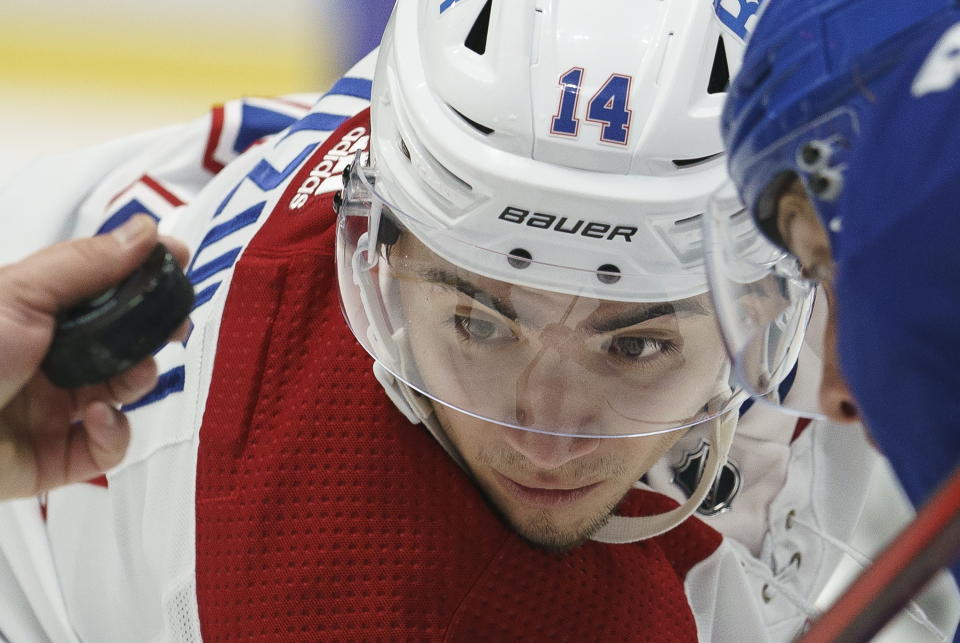 Montreal Canadiens center Nick Suzuki (14) waits for the puck to drop on a faceoff against the Vancouver Canucks during the first period of an NHL hockey game Thursday, Jan. 21, 2021, in Vancouver, British Columbia. (Jonathan Hayward/The Canadian Press via AP)