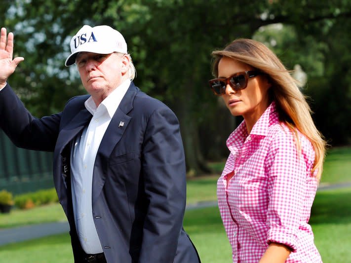 U.S. President Donald Trump waves as he walks with first lady Melania Trump on South Lawn of the White House upon their return to Washington, U.S., from Camp David, August 27, 2017. REUTERS/Yuri Gripas