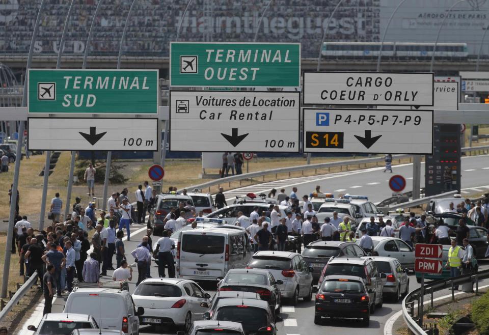 French striking taxi drivers block the access to Orly airport, south of Paris, France, during a national protest against car-sharing service Uber June 25, 2015. (REUTERS/Christian Hartmann)