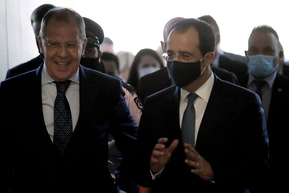 Russian Foreign Minister Sergey Lavrov, left, is greeted by his Cypriot counterpart Nikos Christodoulides as he arrives at the foreign ministry house for a meeting in the capital Nicosia, Cyprus, Tuesday, Sept. 8, 2020. Lavrov is paying an official visit to Cyprus amid heightened tensions over Turkey's search for energy resources in east Mediterranean waters where Greece and Cyprus claim as having exclusive economic rights. (AP Photo/Petros Karadjias)