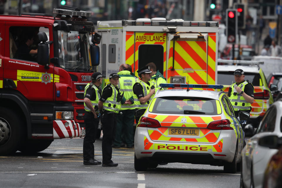 Emergency services at the scene in West George Street, Glasgow, where a man has been shot by an armed officer after another police officer was injured during an attack.