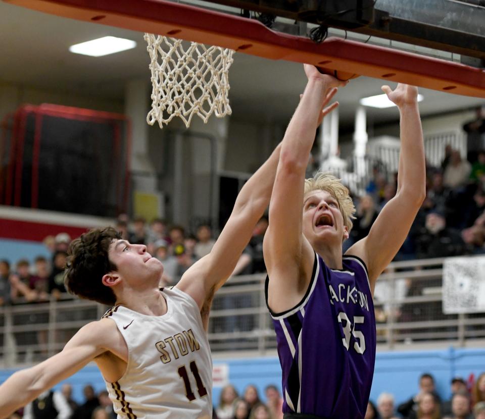 Jackson's Owen Woolbert scores over Stow's AJ Pestello in the fourth quarter of the Division I district final Saturday, March 4, 2023, at Alliance High School.