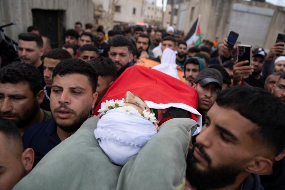 Mourners carry the body of Jehad Abu Alia, who was killed in violence following the death of an Israeli teenager (AP)