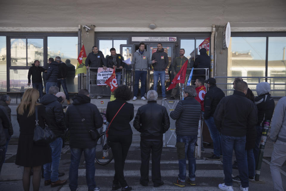 Railway workers gather for a union general assembly meeting at the Gare St-Charles station in Marseille, southern France, Monday, Dec. 9, 2019. Paris commuters inched to work Monday through exceptional traffic jams, as strikes to preserve retirement rights halted trains and subways for a fifth straight day. (AP Photo/Daniel Cole)