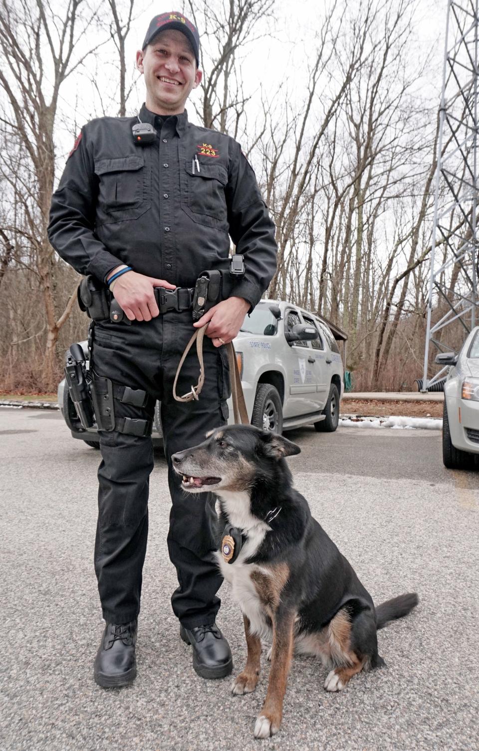 Trooper Daniel S.  O'Neil and Ruby pose for a photograph at the Wickford State Police barracks in 2018 when Ruby was nominated for an American Humane Hero Dog Award.