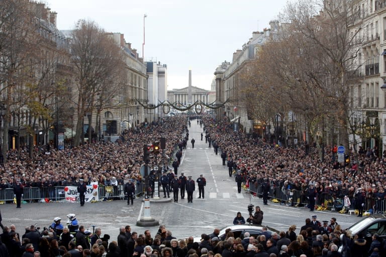 Mourners in front of the La Madeleine Church in Paris ahead of the funeral ceremony for French rock singer and cultural icon Johnny Hallyday