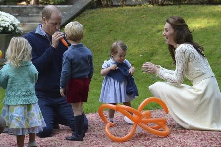 Britain's Prince William blows up a balloon as he and his wife Kate, the Duchess of Cambridge, take part in a tea party with their children Prince George and Princess Charlotte at Government House in Victoria, British Columbia, Canada September 29, 2016. REUTERS/Jonathan Hayward/Pool