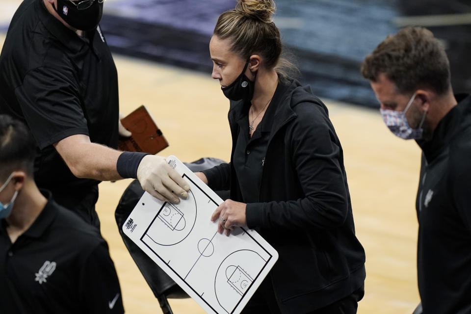 San Antonio Spurs assistant coach Becky Hammon breaks from a huddle during a timeout in the second half of an NBA basketball game against the Los Angeles Lakers in San Antonio, Wednesday, Dec. 30, 2020. Hammon became the first woman to direct an NBA team, taking over the Spurs after coach Gregg Popovich was ejected in a 121-107 loss to the Lakers. (AP Photo/Eric Gay)