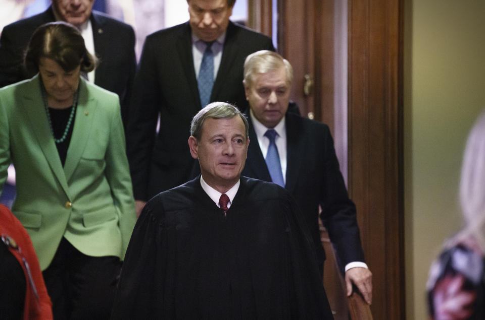 Chief Justice of the United States John Roberts, followed by Sen. Dianne Feinstein, D-Calif., left, and Senate Judiciary Committee Chairman Lindsey Graham, R-S.C., leaves the Senate chamber after presiding over the impeachment trial and today's acquittal of President Donald Trump, at the Capitol in Washington, Wednesday, Feb. 5, 2020. (AP Photo/J. Scott Applewhite)