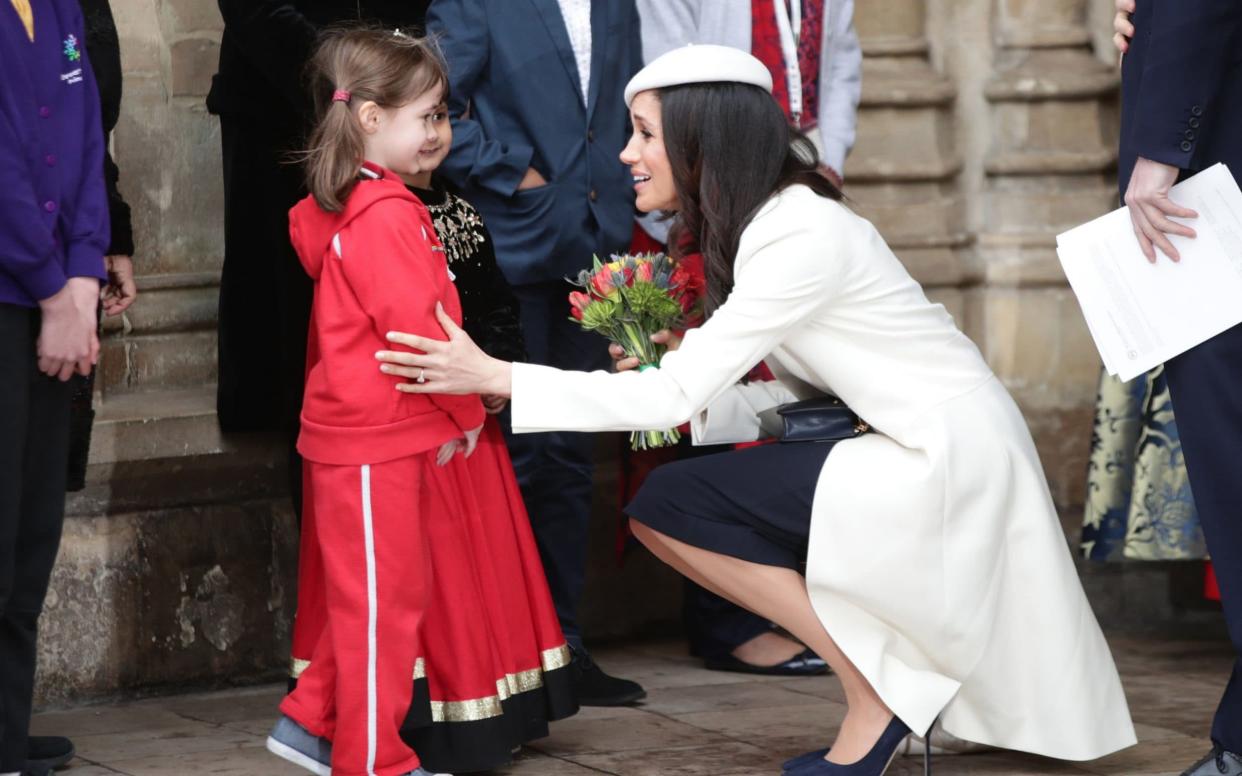 Meghan Markle talking to children as she leaves the Commonwealth Service at Westminster Abbey - PA