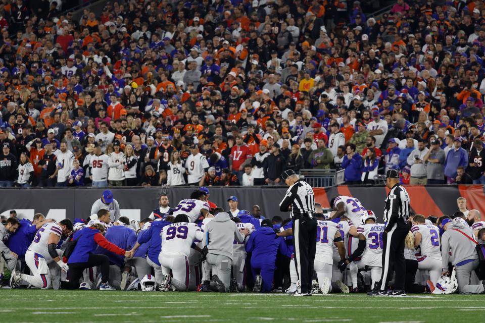 Buffalo Bills players huddle after teammate Damar Hamlin #3 collapsed following a tackle against the Cincinnati Bengals during the first quarter at Paycor Stadium on January 02, 2023, in Cincinnati, Ohio.