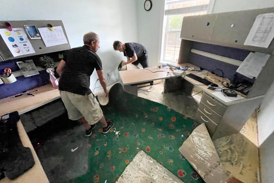 Richard Szabo and Nico Tellez with SERVPRO of Fort Walton Beach remove water-soaked carpet from one of the offices at the Emerald Coast Children's Advocacy Center in Niceville. The building sustained significant water damage after a weekend fire triggered its sprinkler system.