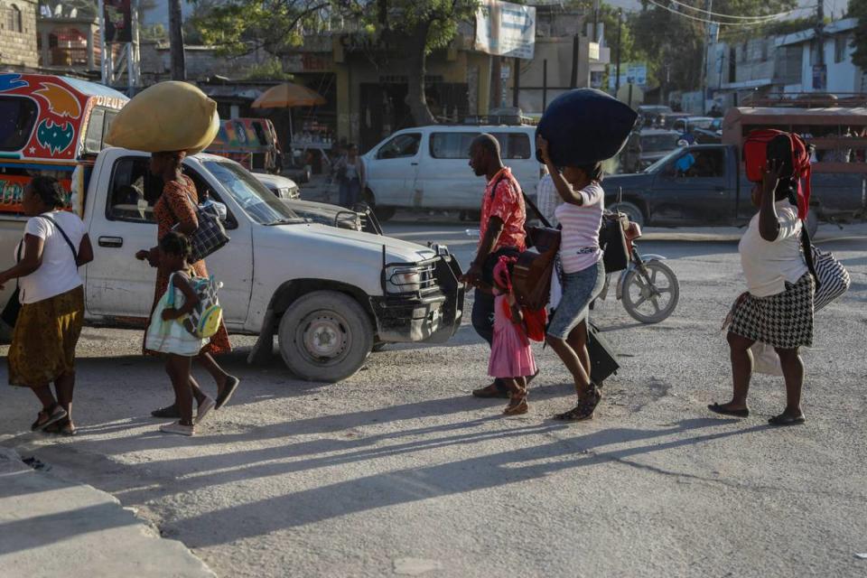 Haitians displaced from their homes due to clashes between armed gangs in Cite Soleil walk down a street in the Tabarre neighborhood as they seek refuge in Port-au-Prince, Haiti, Wednesday, Nov. 15, 2023.