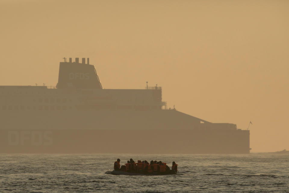 AT SEA, ENGLAND - JULY 22: An inflatable craft carrying migrant men, women and children crosses the shipping lane in the English Channel on July 22, 2021 off the coast of Dover, England. On Monday, 430 migrants crossed the channel from France, a record for a single day. To stem the rising numbers, the British and French governments announced yesterday a deal under which the UK will pay over £54 million and France will double the number of police patrolling the beaches from which migrants launch their boats. (Photo by Dan Kitwood/Getty Images)