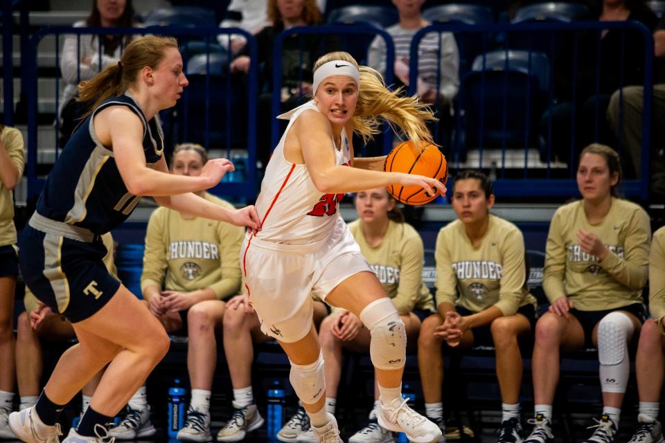 Hope's Kenedy Schoonveld drives past her Trine defender Thursday, March 17, 2022, at UPMC Cooper Fieldhouse in Pittsburgh.