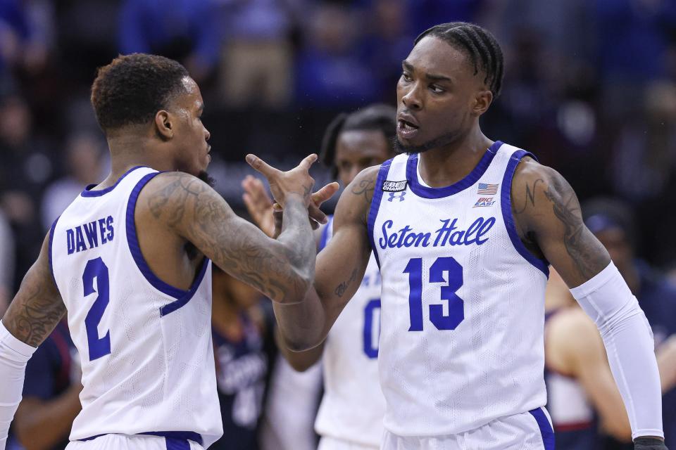 Seton Hall Pirates forward KC Ndefo (13) celebrates with Seton Hall Pirates guard Al-Amir Dawes (2) after a basket during the second half against the Connecticut Huskies at Prudential Center.