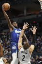 Minnesota Timberwolves forward Taurean Prince (12) shoots as Brooklyn Nets center Blake Griffin (2) defends in the second quarter of an NBA basketball game Sunday, Jan. 23, 2022, in Minneapolis. (AP Photo/Bruce Kluckhohn)