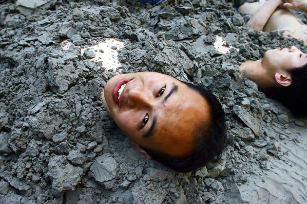 <b>Neck deep mud-bath: for the nerves and joints </b><br> A group of people enjoy a mud therapy session at a sanatorium in Anshan, northeast China's Liaoning province, 21 August 2006. The treatment, which dates back to the Tang Dynasty, is believed to bring pain relieve for various ailments including rheumatoid arthritis, traumatisms and nervous system diorders. <b> AFP PHOTO</b>
