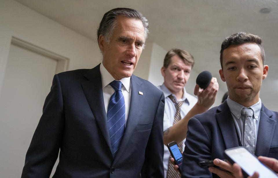 FILE - In this Sept. 11, 2019 file photo, Sen. Mitt Romney, R-Utah, takes questions from reporters as he arrives for votes on pending nominations, at the Capitol in Washington. Romney’s ratcheted-up rhetoric on President Donald Trump is again raising hopes among Trump detractors that the senator could play a key role in the unfolding impeachment saga, though the historic shifts in their relationship mean Romney’s next move is an open question. (AP Photo/J. Scott Applewhite, File)