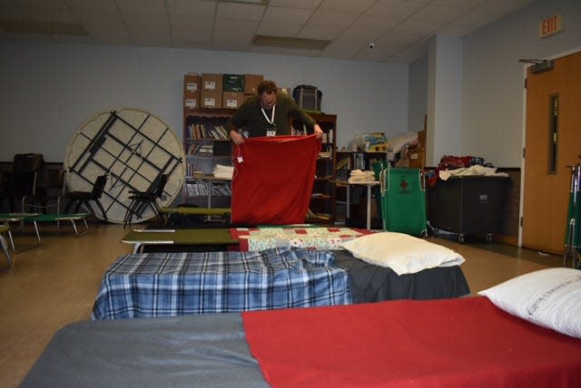 Gaston County Communications Director Adam Gaub prepares beds for the cold weather shelter at Salvation Army on South Broad Street on Wednesday, Jan. 17.