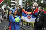 Protestors gather outside an immigration detention hotel where Serbia's Novak Djokovic is believed to stay, in Melbourne, Australia, Friday, Jan. 7, 2022. Locked in a dispute over his COVID-19 vaccination status, Djokovic was confined to the immigration detention hotel in Australia on Thursday as the No. 1 men's tennis player in the world awaited a court ruling on whether he can compete in the Australian Open later this month. (AP Photo/Hamish Blair)