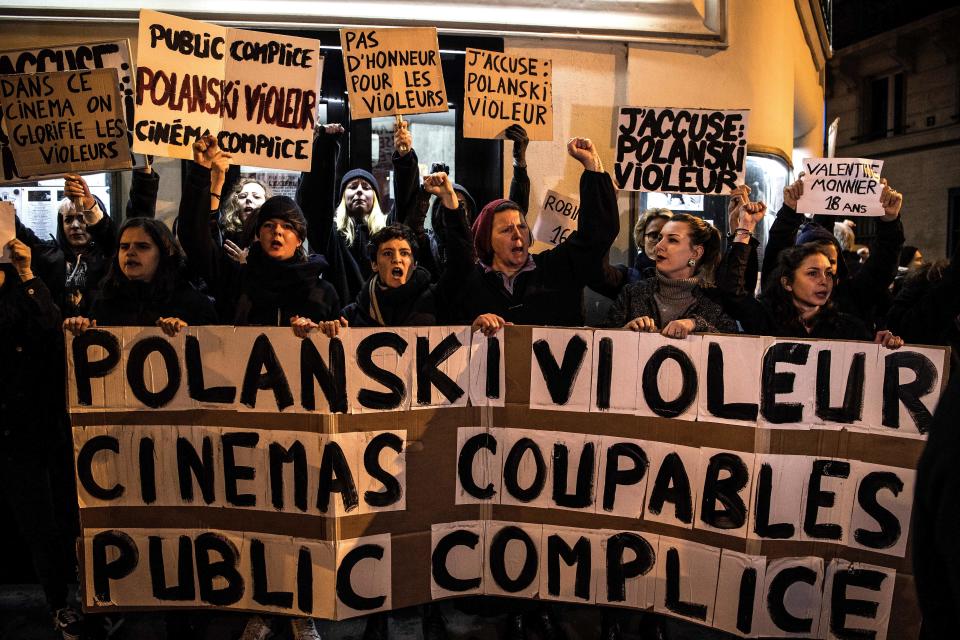 Demonstrators hold banners reading "Polanski rapist, cinemas guilties, public accomplice" during a protest against French-Polish film director Roman Polanski outside the "Champo" cinema hall in Paris on November 12, 2019. - Interviews to promote Polanski's new film "An Officer and a Spy" have been either cancelled or pulled after a new rape allegation against the controversial director on November 8. (Photo by Christophe ARCHAMBAULT / AFP) (Photo by CHRISTOPHE ARCHAMBAULT/AFP via Getty Images)