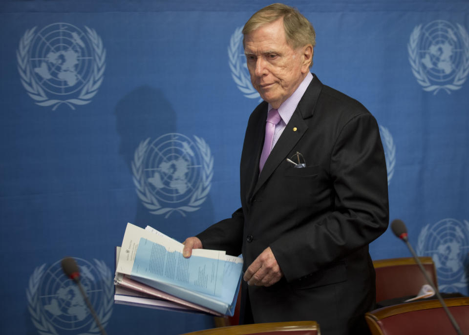 Retired Australian judge Michael Kirby, chairperson of the commission of Inquiry on Human Rights in the Democratic People's Republic of Korea, arrives with the commission's report for a press conference at the United Nations in Geneva, Switzerland, Monday, Feb. 17, 2014. A U.N. panel has warned North Korean leader Kim Jong Un that he may be held accountable for orchestrating widespread crimes against civilians in the secretive Asian nation. Kirby told the leader in a letter accompanying a yearlong investigative report on North Korea that international prosecution is needed "to render accountable all those, including possibly yourself, who may be responsible for crimes against humanity." (AP Photo/Anja Niedringhaus)