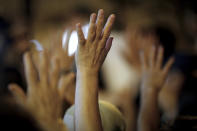 Protesters raise hands signal their 5 demands as they gather outside the Queen Elizabeth Stadium in Hong Kong, Thursday, Sept. 26, 2019. Riot police on Thursday begun securing a stadium in downtown Hong Kong ahead of a town hall session by embattled city leader Carrie Lam, aimed at cooling down months of protests for greater democracy in the semi-autonomous Chinese territory. (AP Photo/Vincent Thian)