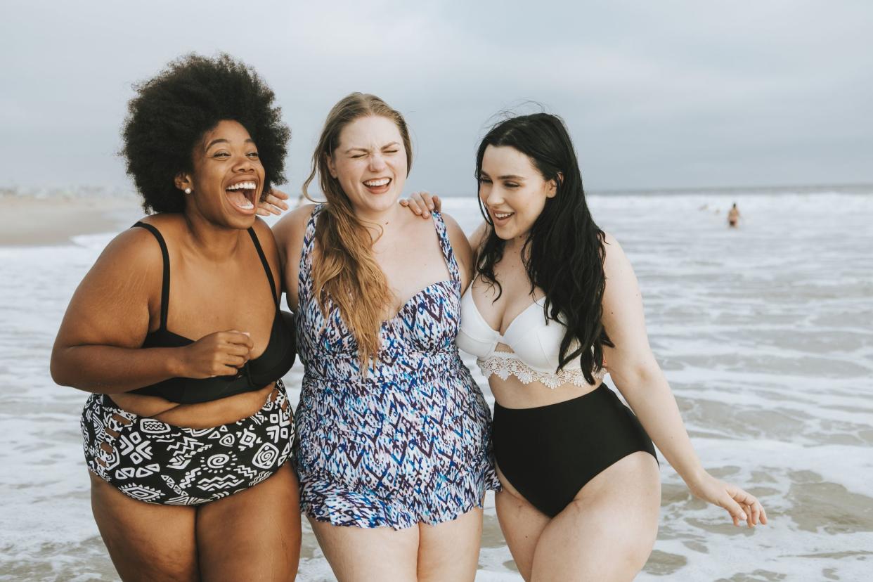 Cheerful plus size women enjoying the beach