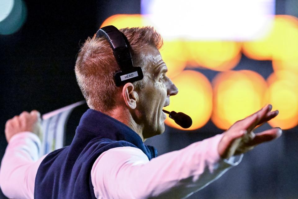 Central Valley Christian head coach Mason Hughes signals to his players against Sanger in a Central Section Division II high school quarterfinal football playoff Thursday, November 10, 2022.