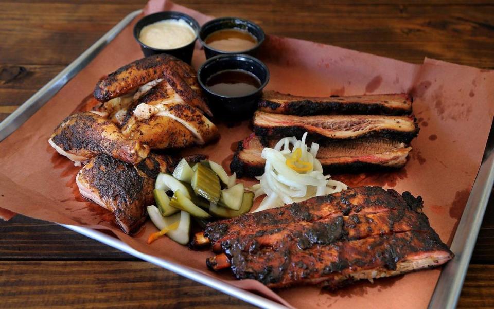 A display of delicious barbecue meats, including homemade sauces, spice rubbed chicken, spare ribs with a jerk rub, from The Drinking Pig.