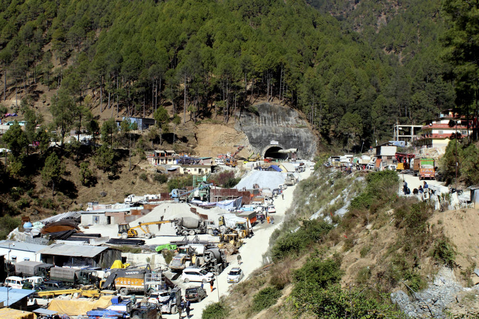 A number of heavy machinery are seen parked at the entrance to the site of an under-construction road tunnel that had collapsed trapping 40 workers in Silkyara in the northern Indian state of Uttarakhand, Wednesday, Nov. 22, 2023. (AP Photo)