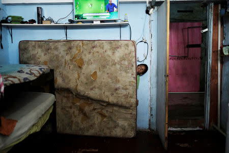 A boy is seen inside his flat at the abandoned Prestes Maia textile factory occupied by a homeless movement in downtown Sao Paulo, Brazil, May 10, 2018. REUTERS/Nacho Doce