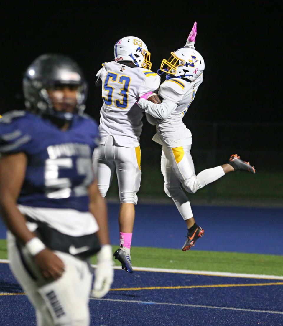 Irondequoit running back Lamere Smith (1) right, celebrates his first quarter touchdown with teammate Evan Shaper (53), against Brighton during their Section V matchup Friday, Oct. 21, 2022, at Brighton High School.