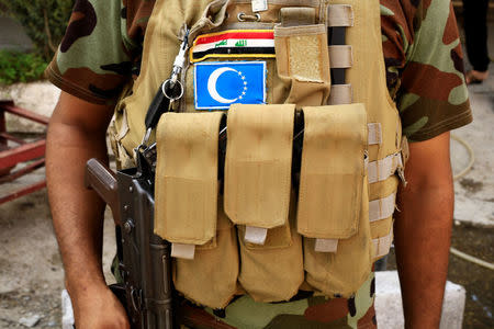 A soldier wearing uniform of Shi'ite Popular Mobilization Forces (PMF) is seen at Turkoman neighbourhood Shia in Tuz Khurmato, Iraq September 24, 2017. REUTERS/Thaier Al-Sudani