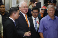 Former Malaysian Prime Minister Najib Razak, second from left, leaves Kuala Lumpur High Court in Kuala Lumpur, Monday, Nov. 11, 2019.A Malaysian judge on Monday ordered Najib to enter a defense at his first corruption trial linked to the multibillion-dollar looting at the 1MDB state investment fund that helped spur his shocking election ouster last year. (AP Photo/Vincent Thian)
