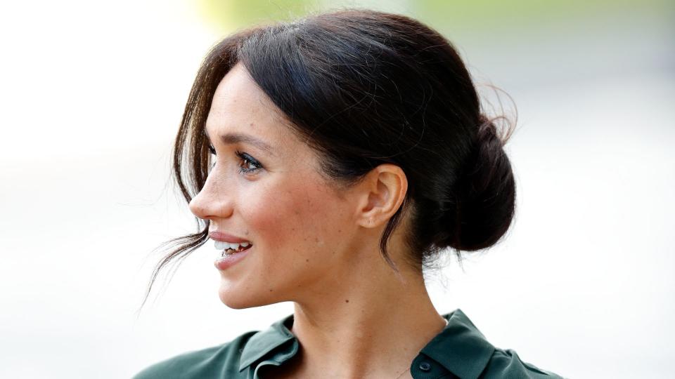 side-profile of Meghan Markle wearing a low updo