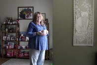 In this Saturday, Oct. 17, 2020, photo Cathy Badalamenti poses for a portrait in her Lombard, Ill., home. Badalamenti has also struggled with her vote once again. In 2016, the Independent eschewed both Trump and Clinton and voted for a third-party candidate, despite having voting twice for former president Barack Obama. (AP Photo/Charles Rex Arbogast)