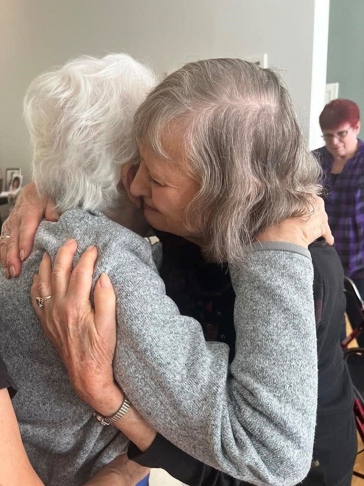 Evelyn Mintzer and Caryl Calsyn hug and say their final goodbyes at the reunion.