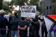 <p>A demonstrator holds a placard, during a protest following the death of Mahsa Amini, outside the Iranian Embassy, in Athens, Greece, September 22, 2022. REUTERS/Costas Baltas</p> 