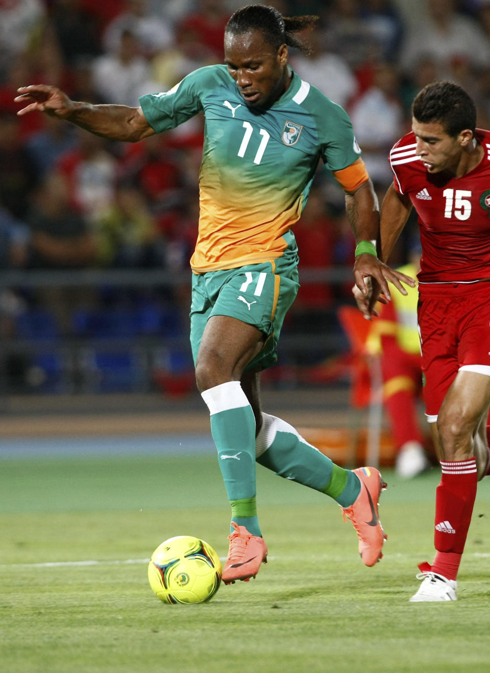 FILE - In this June 9, 2012, file photo, Ivory Coast's Didier Drogba, left, challenges for the ball with Morocco's Benlamalem Ismail, right, during their World Cup qualifying match between Ivory Coast and Morocco, in Marrakech, Morocco. Captain and national idol Didier Drogba remains at the center of the country's hopes despite turning 36 last month. (AP Photo/Abdeljalil Bounhar, File)