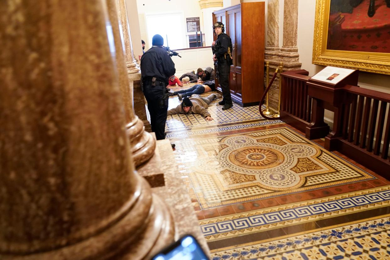 U.S. Capitol Police hold protesters at gunpoint near the House Chamber inside the U.S. Capitol on Wednesday, Jan. 6, 2021, in Washington.