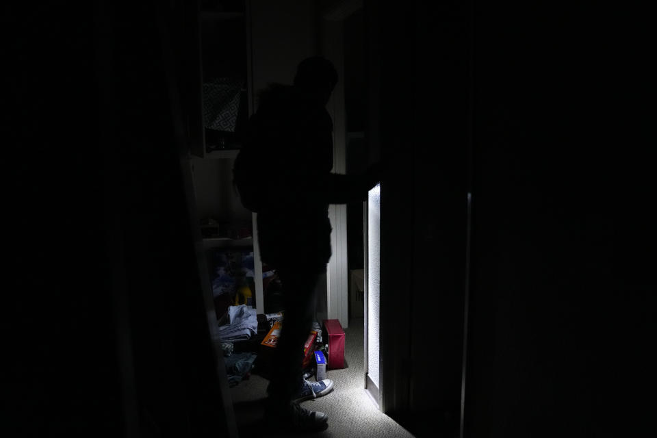 Jarod Valentin walks through his apartment after an earthquake in Rio Dell, Calif., Tuesday, Dec. 20, 2022. A strong earthquake shook a rural stretch of Northern California early Tuesday, jolting residents awake, cutting off power to thousands of people, and damaging some buildings and a roadway, officials said. (AP Photo/Godofredo A. Vásquez)