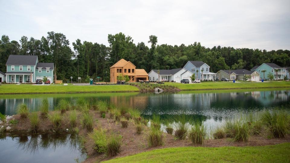 This June 7, 2019 photo, shows the Stonoview development on Johns Island, near Charleston, South Carolina, where builders are required to build retention ponds to store rainwater and prevent flooding. Johns Island residents have opposed such dense developments out of fear that they will worsen the flooding. Developments in disaster prone areas means big bucks for builders, but leaves homeowners in some communities at risk. (Ellen O'Brien/News21 via AP)