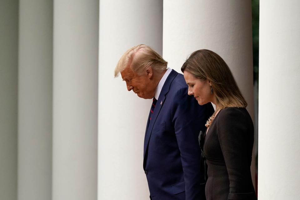 President Donald Trump walks with Judge Amy Coney Barrett to a news conference to announce Barrett as his nominee to the Supreme Court in the Rose Garden at the White House, Saturday, Sept. 26, 2020, in Washington.