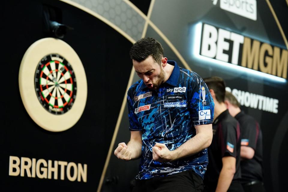 Luke Humphries celebrates after beating Michael Smith in Brighton (Zac Goodwin/PA) (PA Wire)