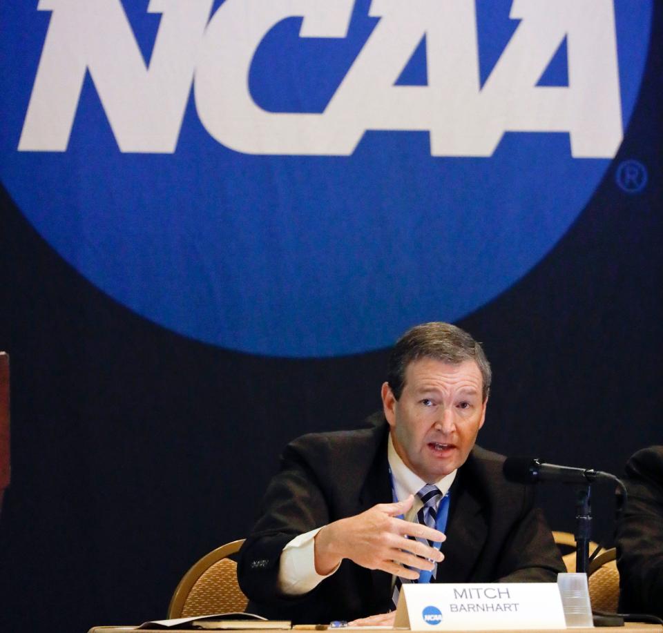 In this Jan. 19, 2017, file photo, Mitch Barnhart, athletic director at Kentucky, takes part in a panel discussion at the NCAA Convention in Nashville, Tenn.